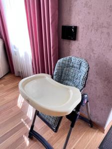 a chair sitting in a room next to a window at Gabala Garden & Mountain View Villa in Gabala