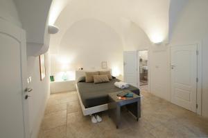 ein Schlafzimmer mit einem Bett und einem Tisch in einem Zimmer in der Unterkunft Casaterramare in Ostuni