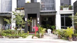 a building with a red fire hydrant in front of it at Slower Life B&B in Jiaoxi