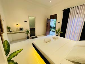 a bedroom with a white bed in a room at Oasis villa in Dickwella