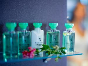 a shelf with a bunch of glass bottles on it at The Cookbook Gastro Boutique Hotel & SPA in Calpe