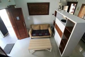 a living room with a couch in the middle of a room at Stylish House Near Pakuwon Mall in Kejayan