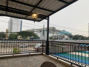 a balcony with a view of a swimming pool at The Tasqya Syariah in Sultan Syarif Kasim II International Airport