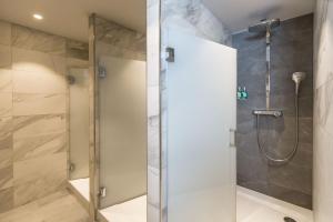 a shower with a glass door in a bathroom at St. Pierre Park Hotel & Golf in St. Peter Port