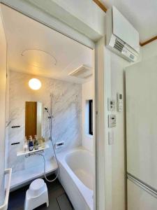 a white bathroom with a tub and a sink at Myabi -Ashinoko - Vacation STAY 72020v in Sekishoato +41 photos