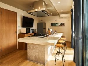 a kitchen with a counter top and some stools at Rakuten STAY VILLA Awaji 101 3 bank beds, Capacity of 9 persons in Minamiawaji