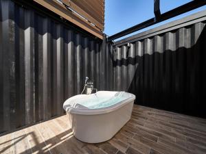 a bath tub sitting on top of a patio at Rakuten STAY VILLA Awaji 102 3 bank beds, Capacity of 9 persons in Minamiawaji