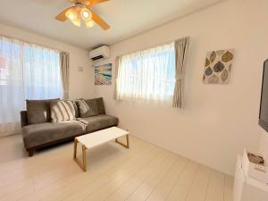 a living room with a couch and a table at Grande Ortho Okinawa Villa Onna 3 - Vacation STAY 83213 in Onna