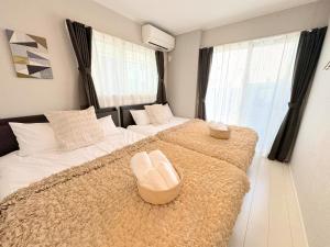 a bedroom with a large bed with a couch and a chair at Grande Ortho Okinawa Villa Onna 3 - Vacation STAY 83213 in Onna