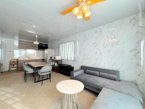 a living room with a couch and a table at Grande Ortho Okinawa Villa Onna 3 - Vacation STAY 91370 in Onna