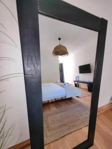 a mirror reflection of a bed in a room at Garden Relax Bungalow "Deluxe Hotel Rooms, Pool, Parking" in Banja Luka +62 photos