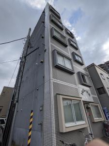 a tall building with windows on the side of it at Tresor Misono - Vacation STAY 9333 in Toyohira