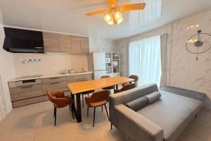 a kitchen and dining room with a table and a couch at Grande Ortho Okinawa Villa Onna 3 - Vacation STAY 91321 in Onna