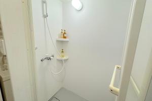 a white bathroom with a shower and a sink at Grande Ortho Okinawa Villa Onna 3 - Vacation STAY 91321 in Onna +33 photos