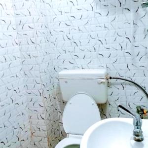 a bathroom with a toilet with a hose at Hotel The Shivay Varanasi Near Kashi Vishwanath Temple in Varanasi