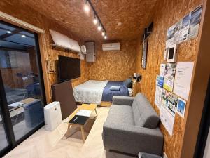宮崎市にあるエクセレントトランクベース宮崎のベッドとソファのある小さな部屋 +34枚の写真