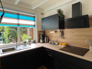 a kitchen with a sink and a window at Haus Rottkäppchen in Extertal