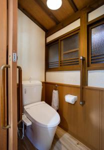 a bathroom with a toilet and two windows at Kameoka - House - Vacation STAY 84233 in Kameoka