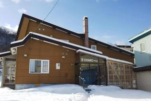 a building with a blue door in the snow at Otaru Village - Vacation STAY 84437 in Otaru +13 photos
