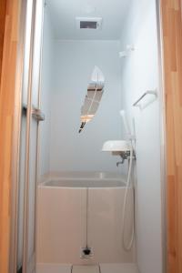 a bathroom with a bath tub and a sink at Otaro Village - Vacation STAY 33029v in Otaru