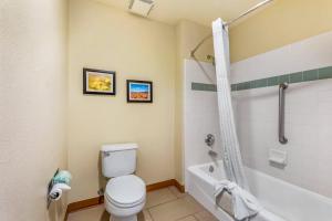 a bathroom with a white toilet and a bath tub at Comfort Inn & Suites Lancaster Antelope Valley in Lancaster +50 photos