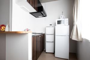 a kitchen with two white refrigerators and a microwave at Tokyo WEST Laffite - Vacation STAY 8299 in Ogikubo