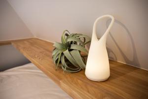 a white vase sitting on a table next to a plant at Tokyo WEST Laffite - Vacation STAY 8298 in Ogikubo