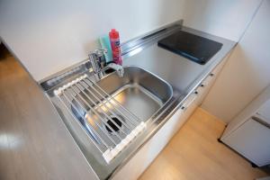 a kitchen sink with a dish drying rack next to it at Tokyo WEST Laffite - Vacation STAY 8298 in Ogikubo +12 photos