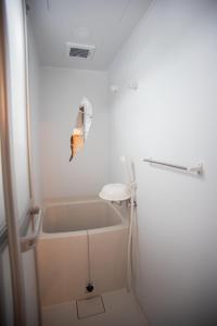 a small bathroom with a tub and a sink at Otaro Village - Vacation STAY 43041v in Otaru