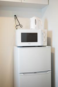 a microwave sitting on top of a refrigerator at Tokyo WEST Laffite - Vacation STAY 8297 in Ogikubo +11 photos