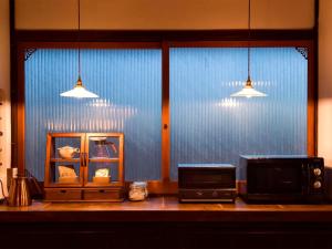 a kitchen counter with a microwave and a toaster oven at Nantan - House - Vacation STAY 84722 in Ōno +35 photos