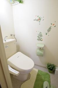 a bathroom with a toilet and a green rug at AMS Tower Nakajima Room 505 - Vacation STAY 8388 in Sapporo