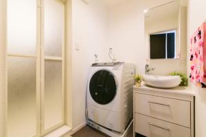 a washing machine in a bathroom with a sink at Room 301 - Vacation STAY 86501 in Fukuoka