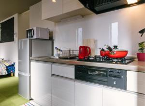 a kitchen with a stove and a refrigerator at Room 301 - Vacation STAY 86501 in Fukuoka