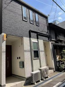 a house with two air conditioners in front of it at Nishikujo 1-16-18 - Vacation STAY 06745v in Osaka