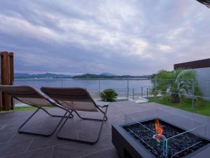 a patio with two chairs and a fire pit at Rakuten STAY HOUSE Amakusa 103 in Kami Amakusa
