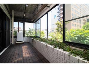 an empty room with windows and plants in a building at Arbor house - Vacation STAY 86731 in Kagoshima