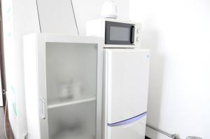 a white refrigerator with a tv on top of it at Ark City Asahikawa - Vacation STAY 8531 in Asahikawa