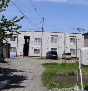 a large white building with cars parked in front of it at Ark City Asahikawa - Vacation STAY 8526 in Asahikawa