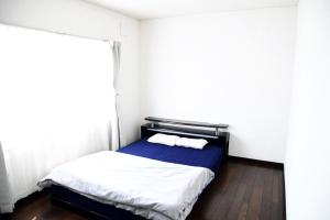 a small bedroom with a bed with a window at Ark City Asahikawa - Vacation STAY 8523 in Asahikawa