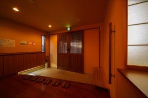 a hallway with shoes on the floor in front of a door at Yufuin Yuki-an - Vacation STAY 86832 in Yufuin +21 photos