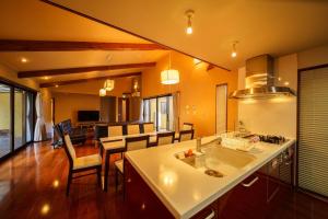 a kitchen and living room with a counter and a table at Yufuin Yuki-an - Vacation STAY 86832 in Yufuin