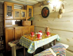 a kitchen with a table with red cups on it at Salamandra Village in Kozevo