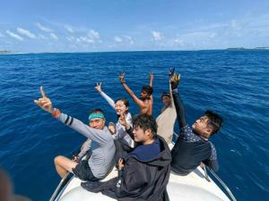 a group of people on a boat in the ocean at Athens View in Guraidhoo