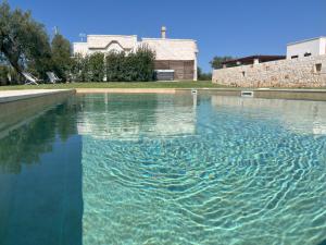 a large pool of water in front of a building at Dimora San Michele in Castellana Grotte