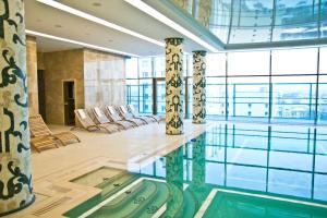 a large room with a pool in a building at Kharkiv Palace Hotel in Kharkiv