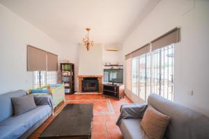 a living room with a couch and a fireplace at Expoholidys- Chalet privado en Castell del Rey in Almería