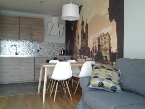 a kitchen and living room with a table and chairs at Garden Corner in Krakow