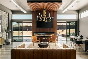 a living room with a couch and a fireplace at M House Modern near park w pool spa in Joshua Tree
