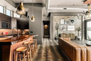 a kitchen with a bar with stools at M House Modern near park w pool spa in Joshua Tree
